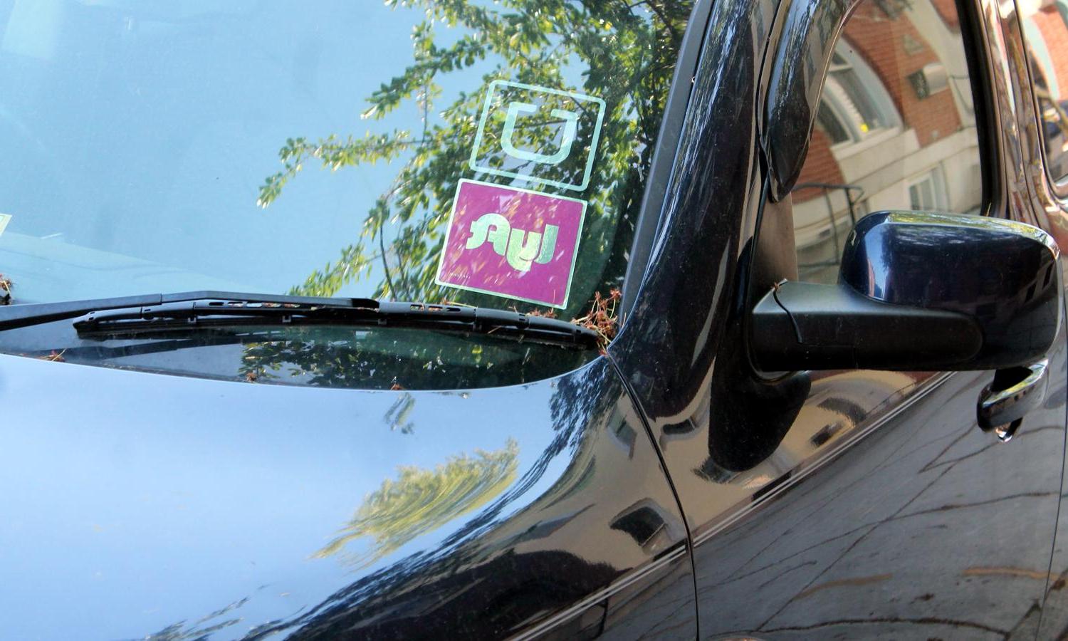 Uber 和 Lyft stickers in a car window