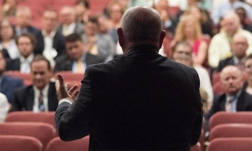 Sonny Perdue seen from behind speaking to an audience